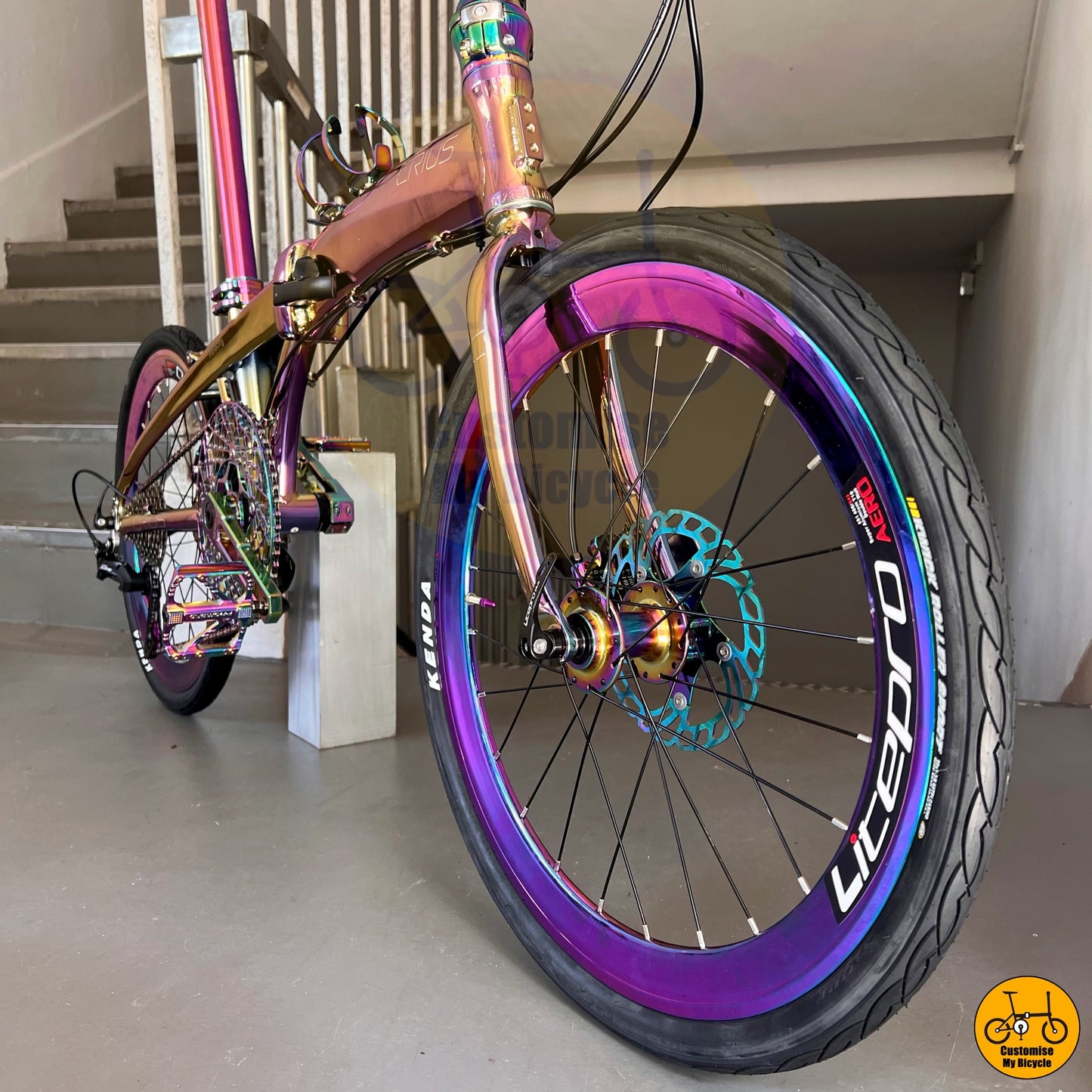 Compact folding bicycle with oil slick saddle for stylish city rides