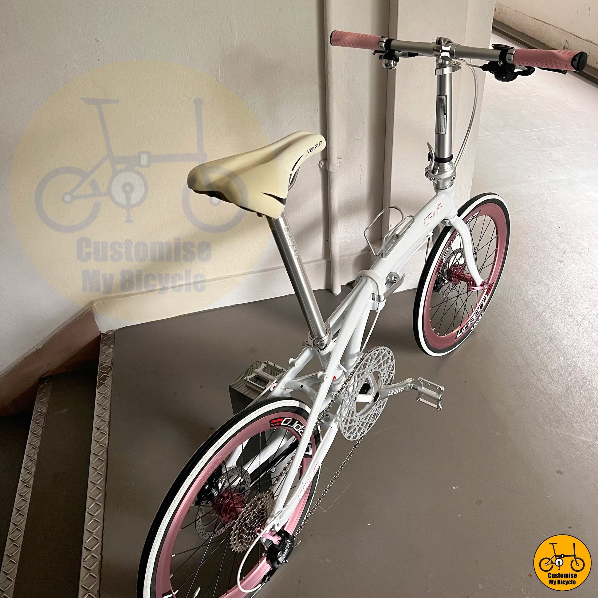 Bifold bike featuring a premium white frame with pastel pink wheels