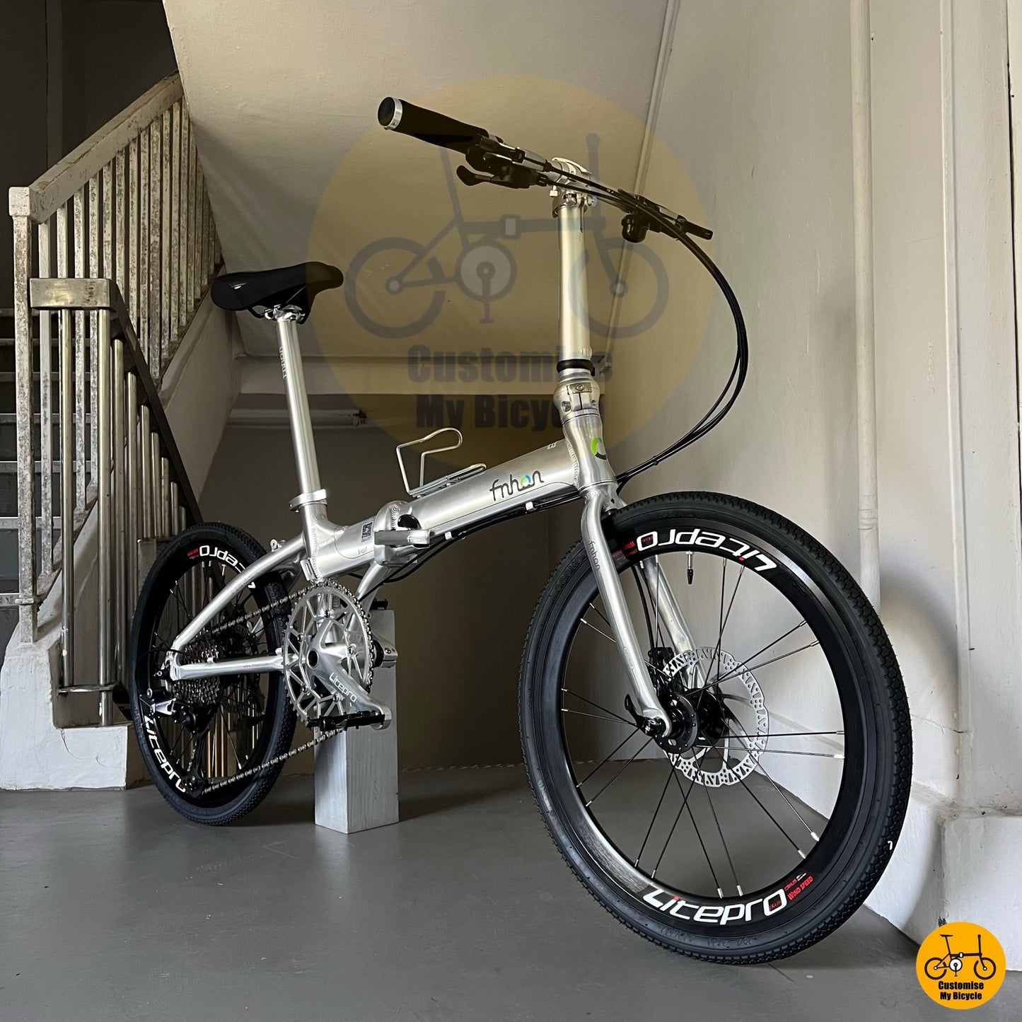 Polished silver foldable bicycle with lightweight frame and 12-speed climbing gears