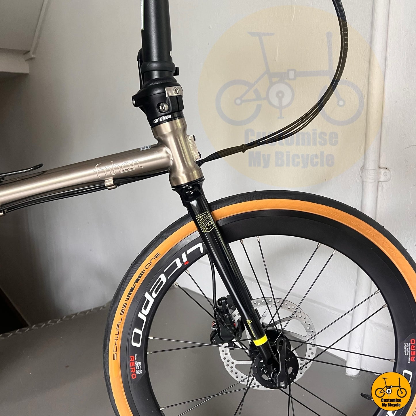 Titanium gold foldie with Schwalbe One tyres and hydraulic brake