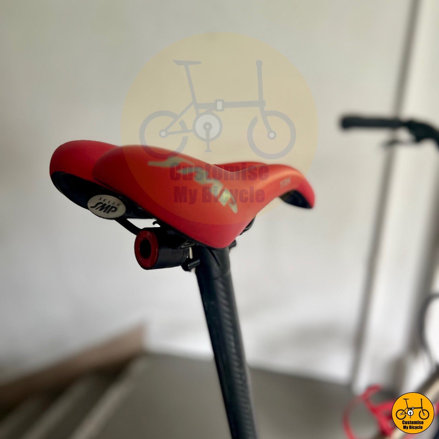 Premium folding bike with Shimano 105, carbon wheels, and top-tier red SMP saddle