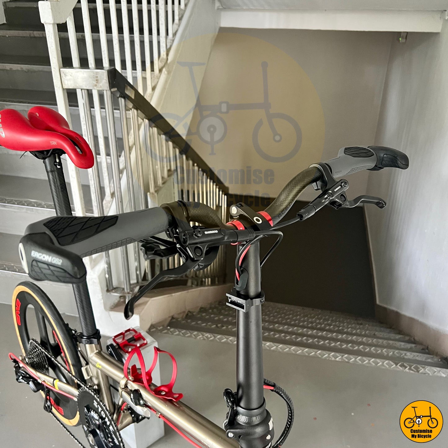 Cockpit setup on sleek titanium gold folding bicycle with Carbonician Trispokes for speed