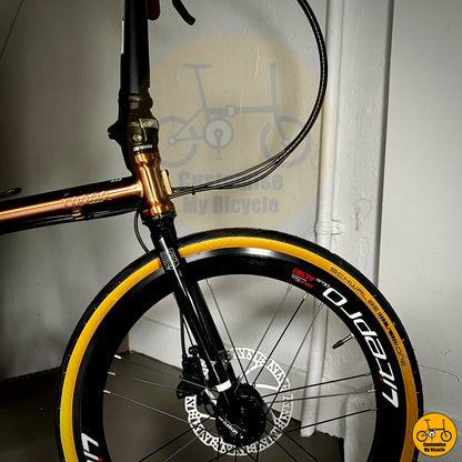 Rose gold Fnhon Gust 20-inch folding bike with Schwalbe One tan wall tyres
