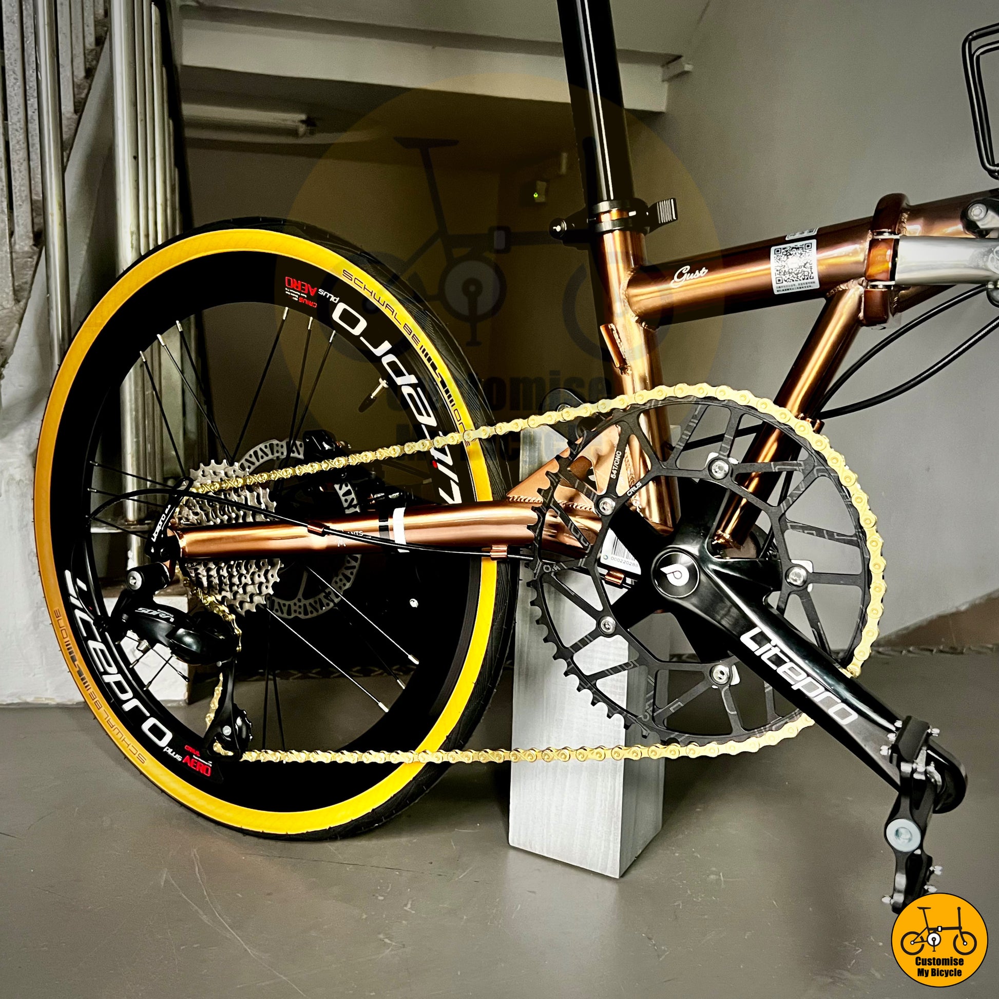 Foldable bike with a stunning rose gold frame and black accents
